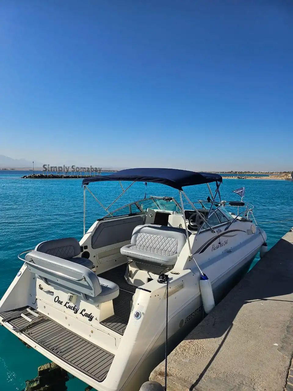 One Lucky Lady private boat moored in the turquoise water at Soma Bay marina